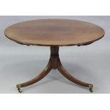 A regency mahogany tilt-top centre table with reeded edge, on vase-turned centre column & three