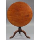 A George III mahogany tripod table with one-piece circular tilt-top, on baluster turned centre