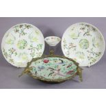 A pair of Chinese porcelain saucer dishes painted with blossoming boughs & flowers in coloured