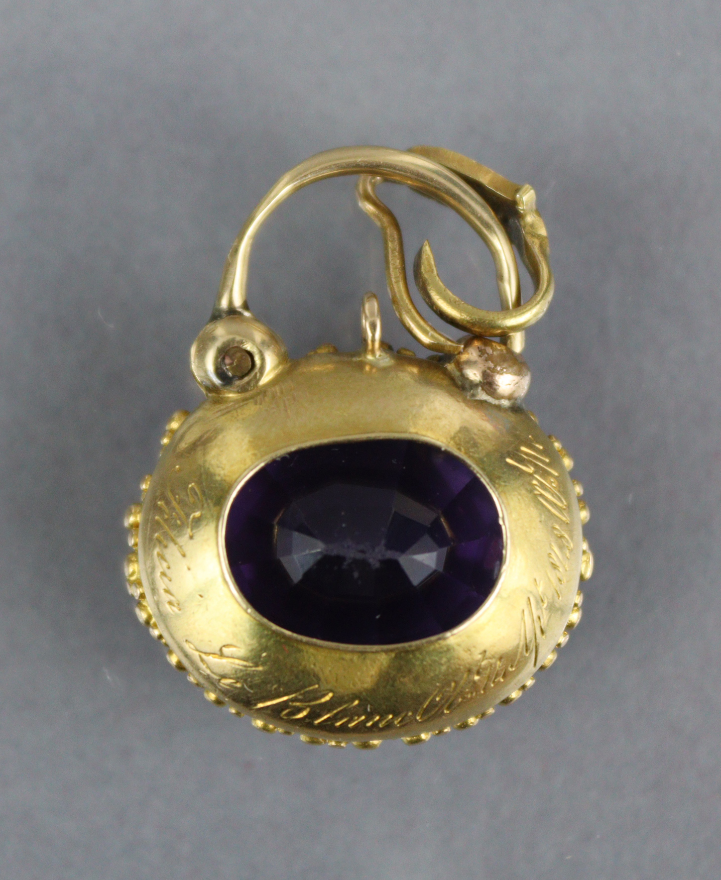 A Victorian amethyst pendant, the oval stone measuring approx. 18mm x 15mm x 9mm, set within a - Image 3 of 3