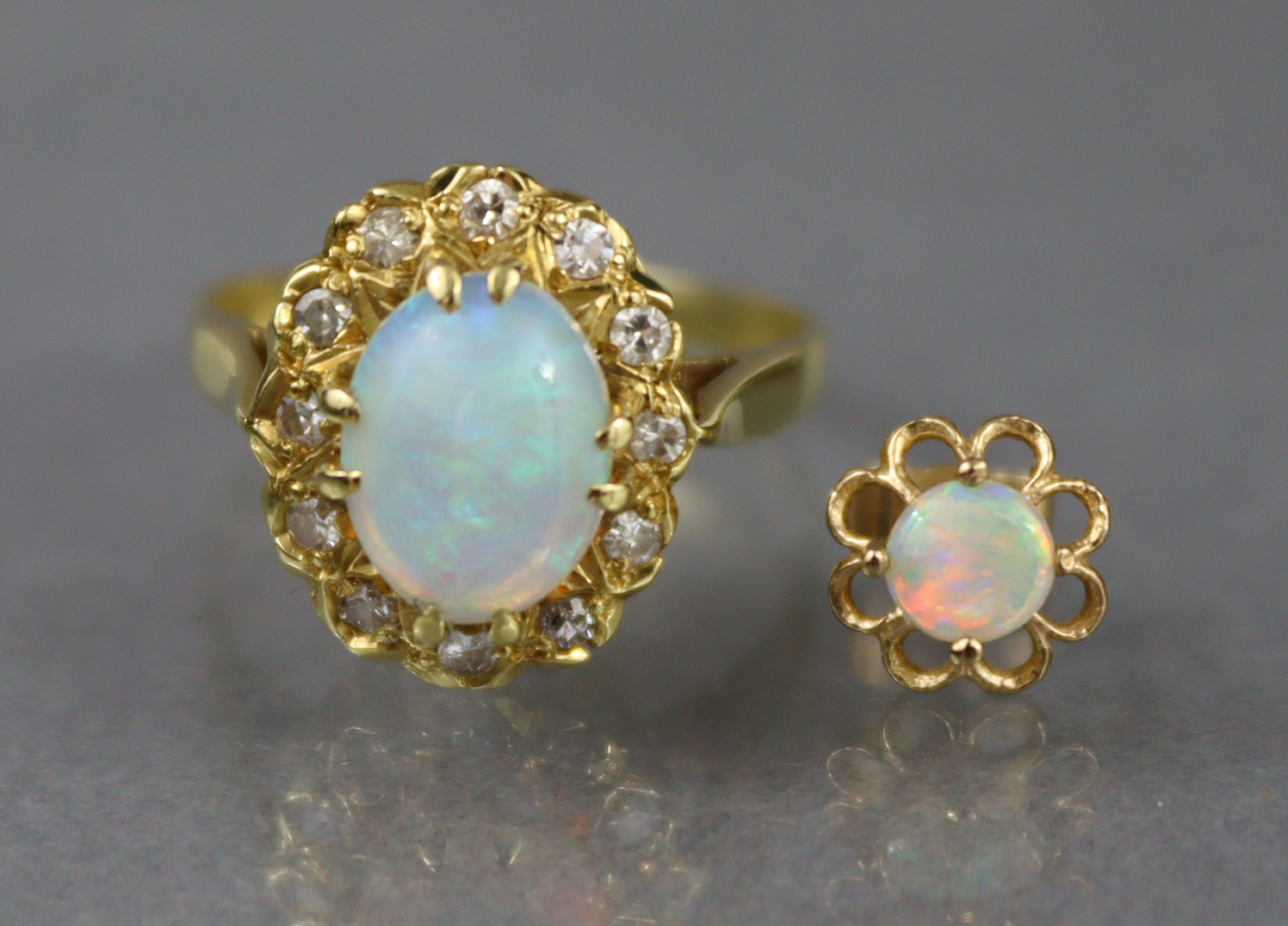 An 18ct. gold ring set oval opal within a border of small diamonds, Birmingham hallmarks for 1875;