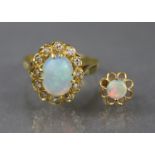 An 18ct. gold ring set oval opal within a border of small diamonds, Birmingham hallmarks for 1875;