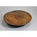 A 19th century circular “lazy Susan”, the revolving top with moulded edge & on turned pedestal base;