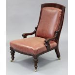 A Victorian Athenian-style carved mahogany easy chair, the padded back & seat upholstered brass-