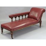 A Victorian carved oak frame chaise longue upholstered brass-studded crimson leather, with foliate