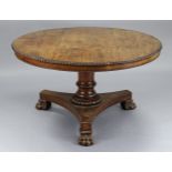 A George IV carved & figured rosewood centre table, the circular top with egg-&-dart edge, on