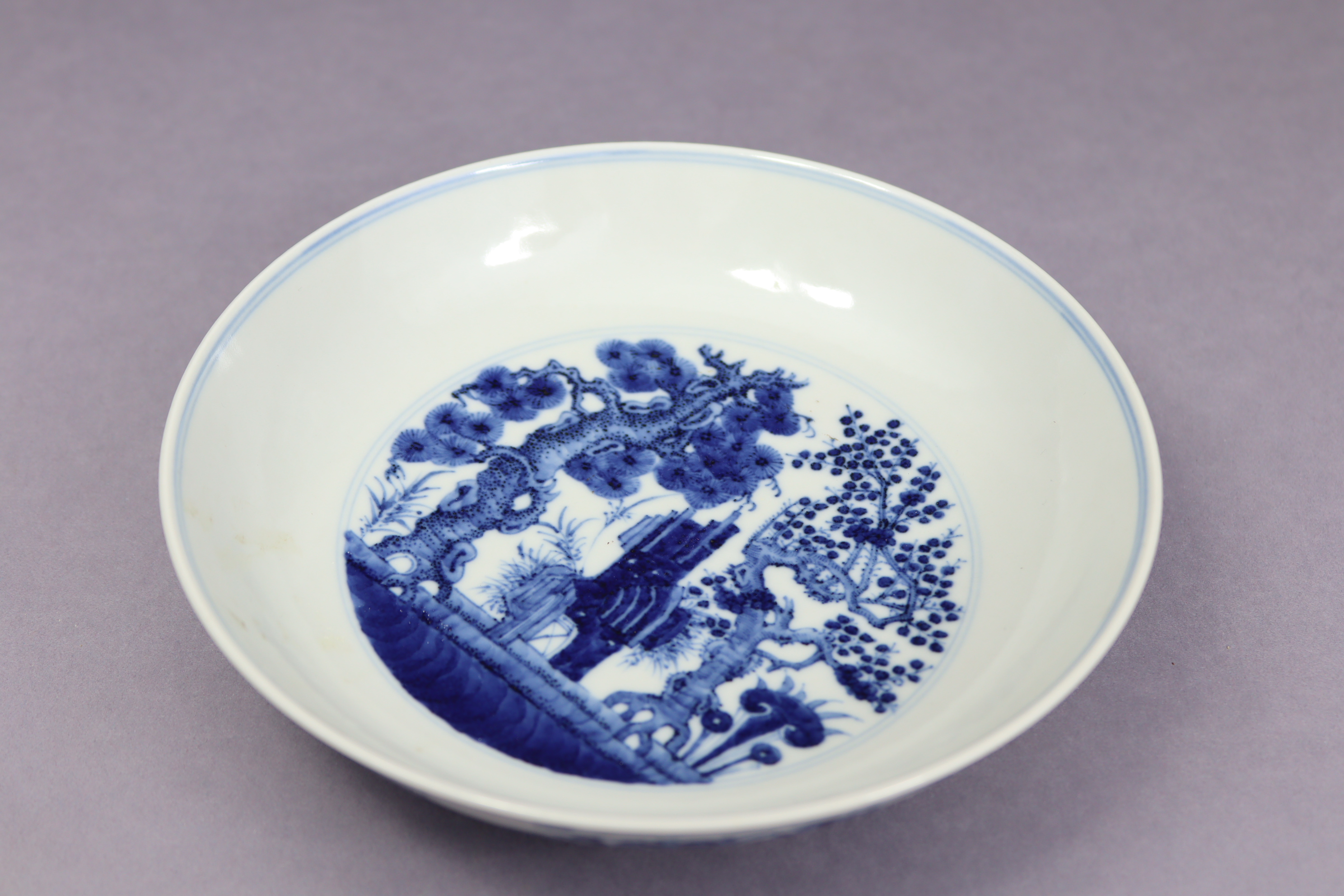 A Chinese blue & white porcelain shallow bowl, the centre decorated with pine, lingzhi, & prunus - Image 3 of 8