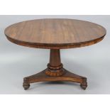 A William IV rosewood centre table, the circular tilt-top with overhang edge, on tapered centre