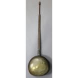 An 18th/19th century engraved brass warming pan with long tapered steel handle.