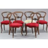 A set of six mid-Victorian carved rosewood dining chairs, each with pierced centre rail to the