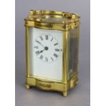 A carriage timepiece in gilt-brass case, with black roman numerals to the white enamel dial, on