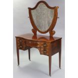 An early 19th century inlaid mahogany serpentine-front dressing chest, with shield-shaped swing