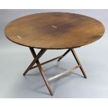 An early Victorian mahogany circular coaching table, on fold X-supports with plain stretchers; 44”