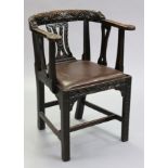 A late Victorian carved oak armchair in the 17th century style, with pierced splat back, padded