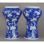 A pair of 19th century Chinese porcelain blue & white vases of tall waisted form with wide