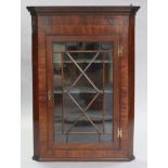 An 18th century mahogany hanging corner cabinet, with moulded cornice & three shaped shelves,