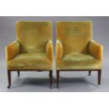 A pair of mahogany frame Edwardian square armchairs upholstered yellow velour, on square tapered