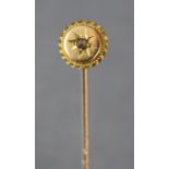 A 15ct. gold stick-pin, the circular head set small diamond, cased.