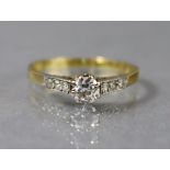 A diamond ring, the round-cut centre stone approx. 0.2 carat, a row of three smaller diamonds to