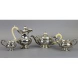 A GEORGE V SILVER FOUR-PIECE TEA SERVICE of melon shape with moulded leaf-scroll borders, each on