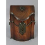 A George III mahogany small knife box of serpentine shape, with sloping hinged lid & original