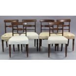 A set of six regency mahogany bow-back dining chairs with carved centre rails, padded seats, & on