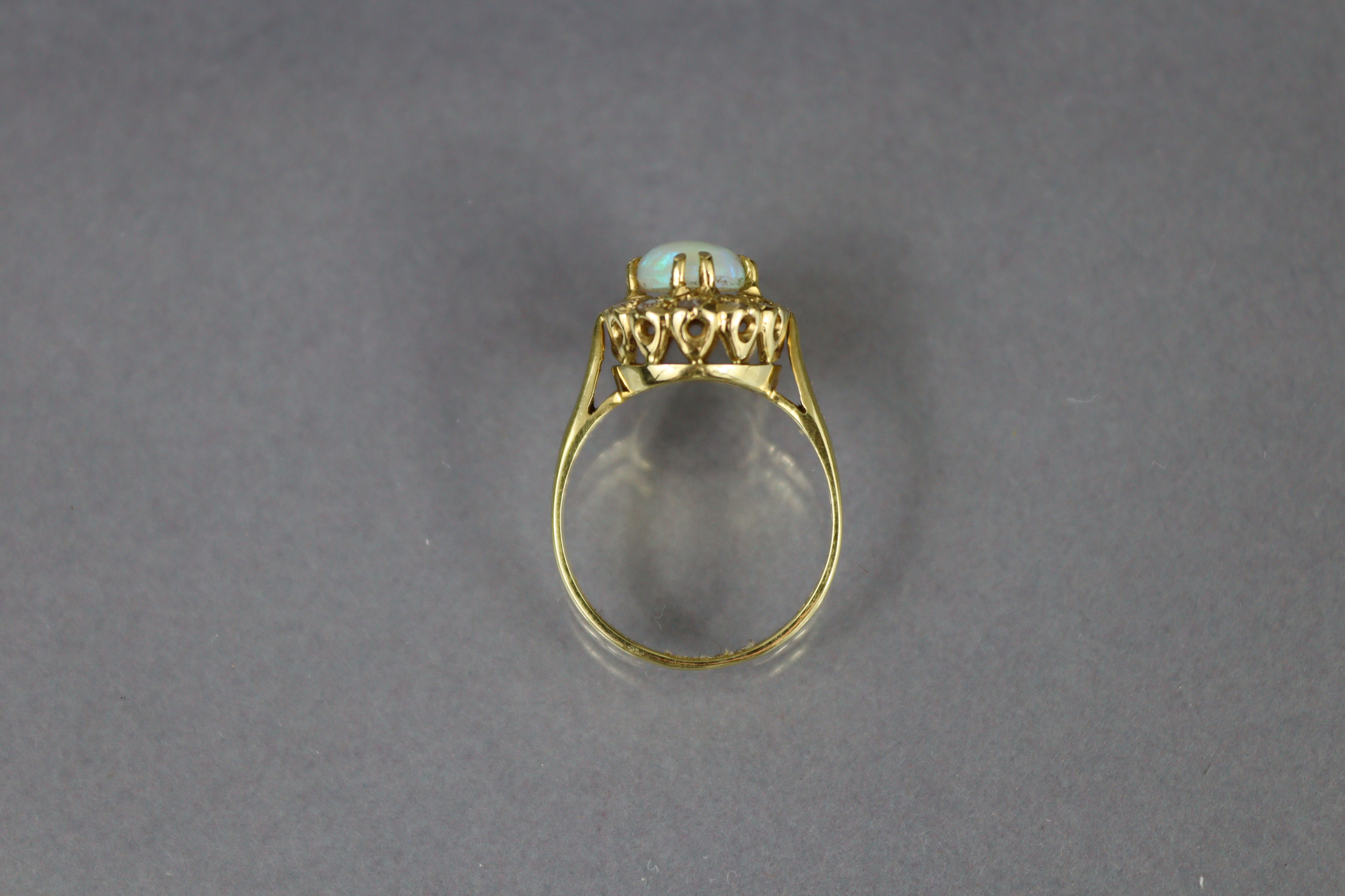 An 18ct. gold ring set oval opal within a border of small diamonds, Birmingham hallmarks for 1875; - Image 5 of 6