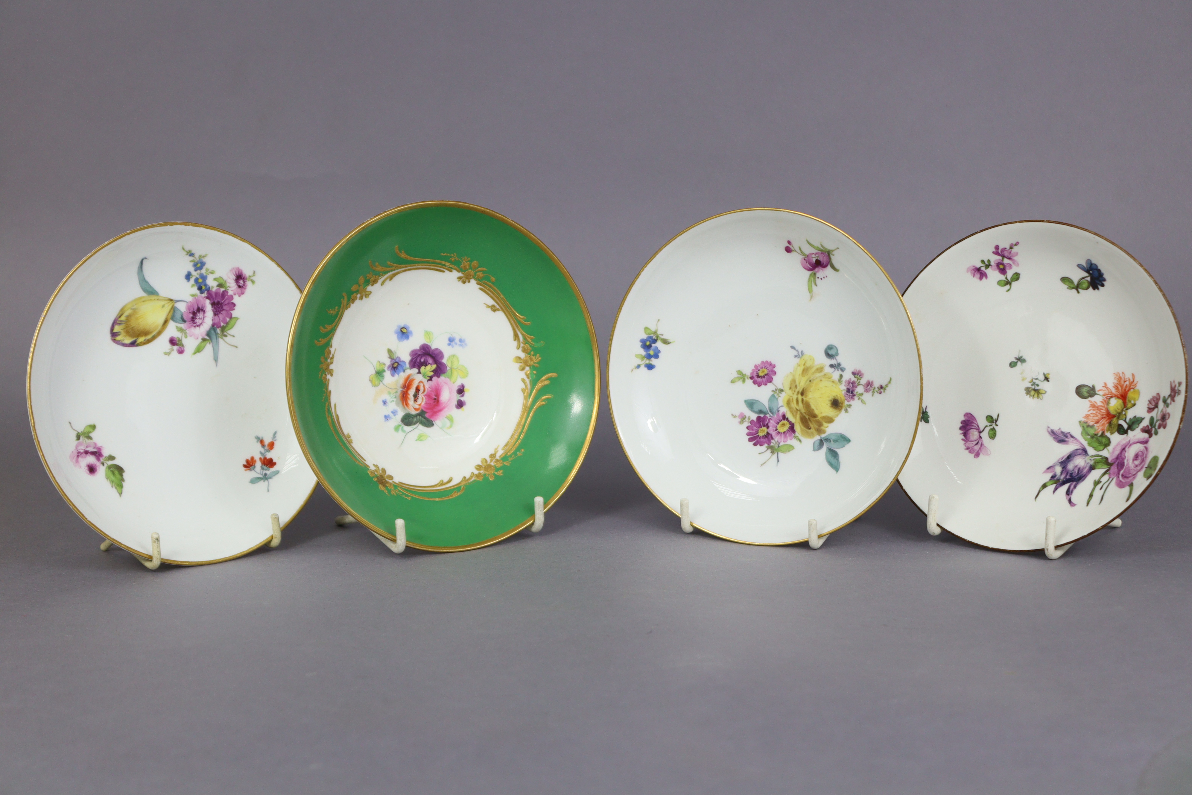 An 18th century Meissen porcelain saucer painted with flower-sprays & with brown rim, 5¼” diam.; a