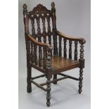 A Victorian carved oak armchair in the gothic style, the tall back & scroll arms with pierced