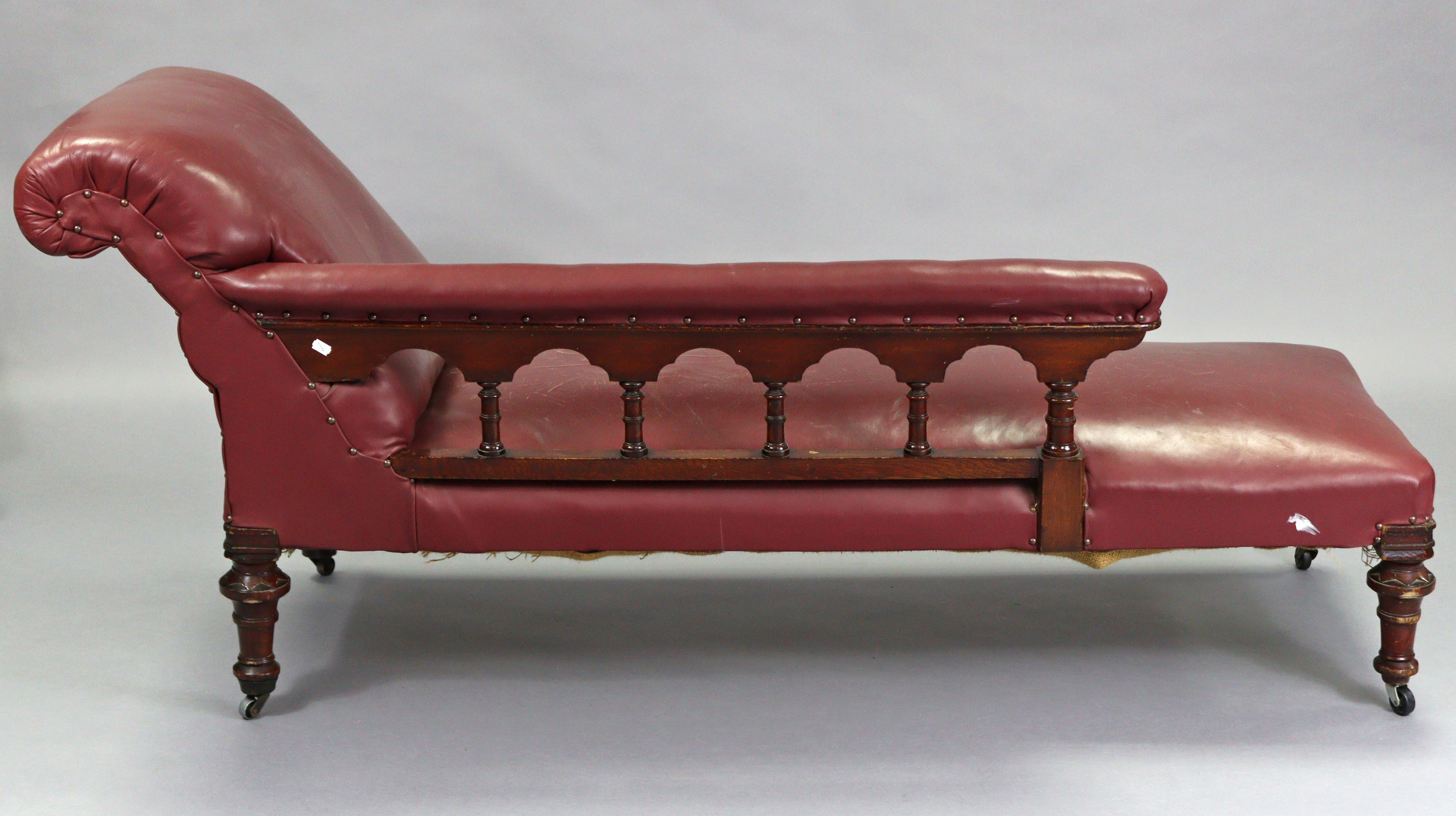 A Victorian carved oak frame chaise longue upholstered brass-studded crimson leather, with foliate - Image 5 of 6