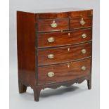 An early 19th century inlaid mahogany bow-front chest, fitted two short & three long drawers with