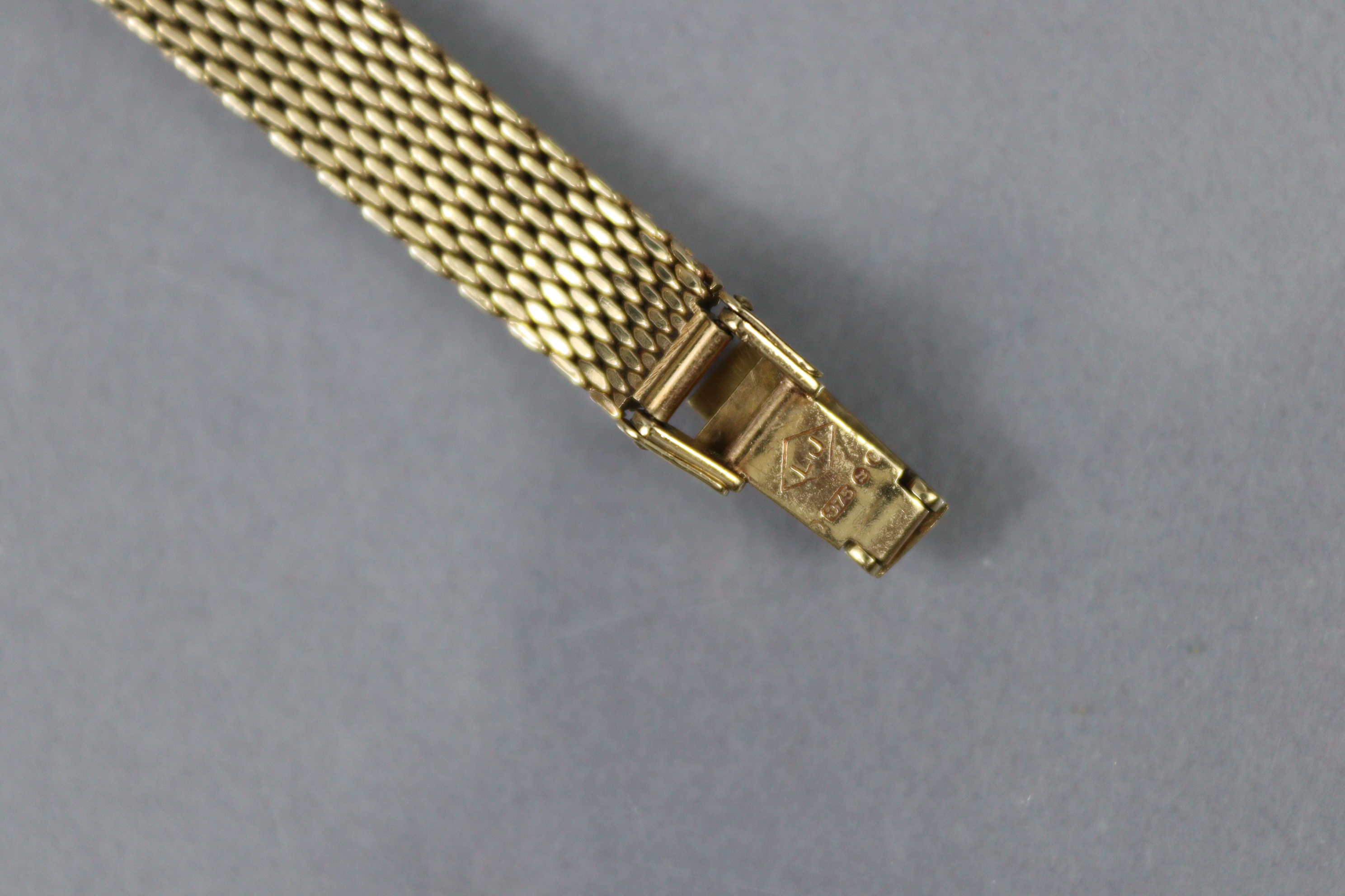 A Tissot 9ct. gold ladies’ bracelet watch with baton numerals to the small circular silvered dial, - Image 4 of 4