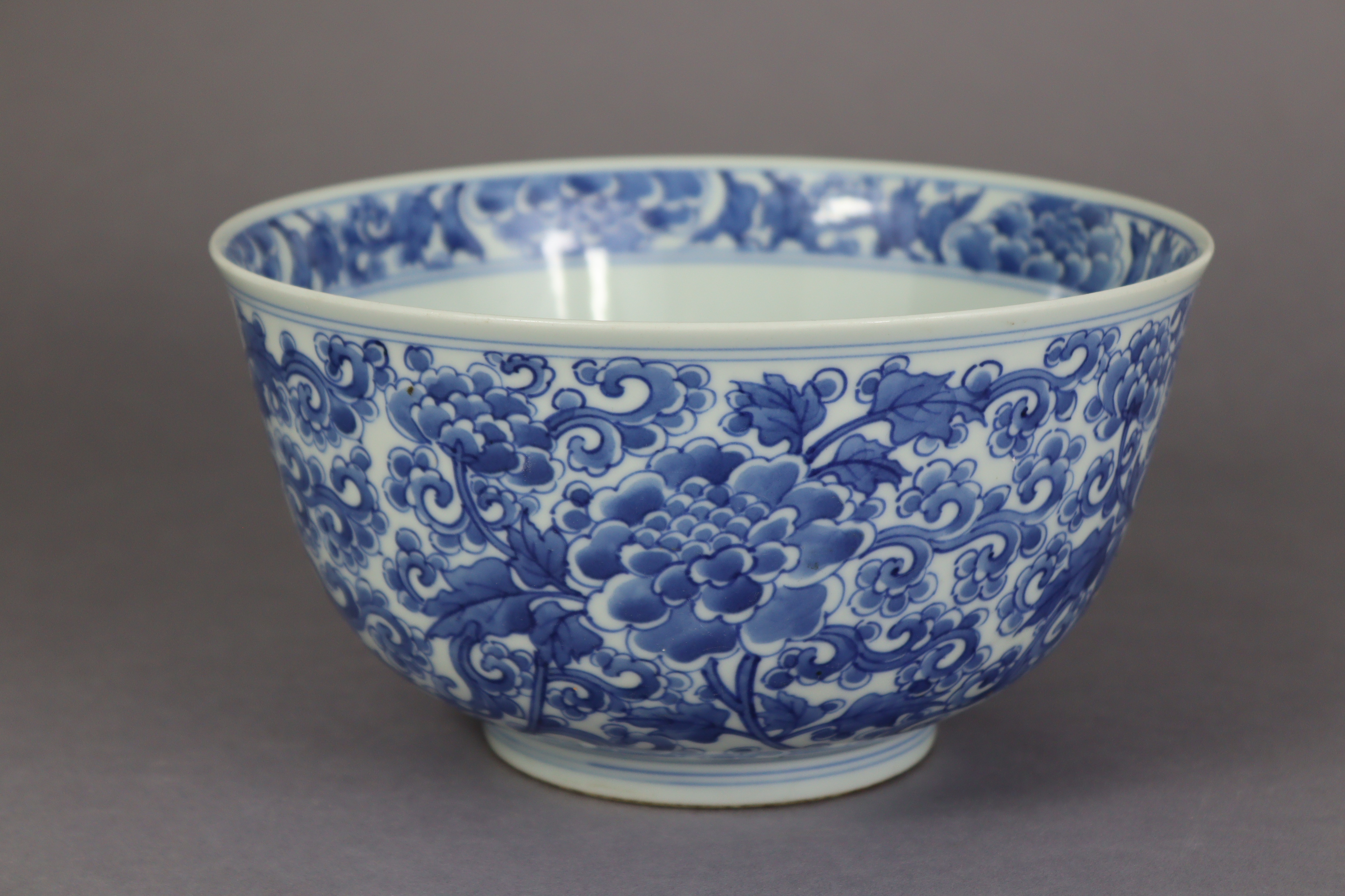 A Chinse blue & white porcelain deep bowl, decorated to the interior & exterior with scrolling