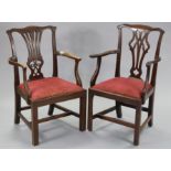 A matched pair of George III mahogany Chippendale-style elbow chairs with pierced splat backs,