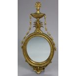 An Adam style gilt frame small oval wall mirror in the Adam style, with tall urn-shaped