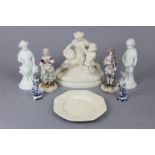 A Victorian parian group of a mother & child with basket of fish & net, on oval rocky base, 7½”