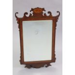 An early 19th century style inlaid mahogany rectangular wall mirror with bevelled plate, in fret-