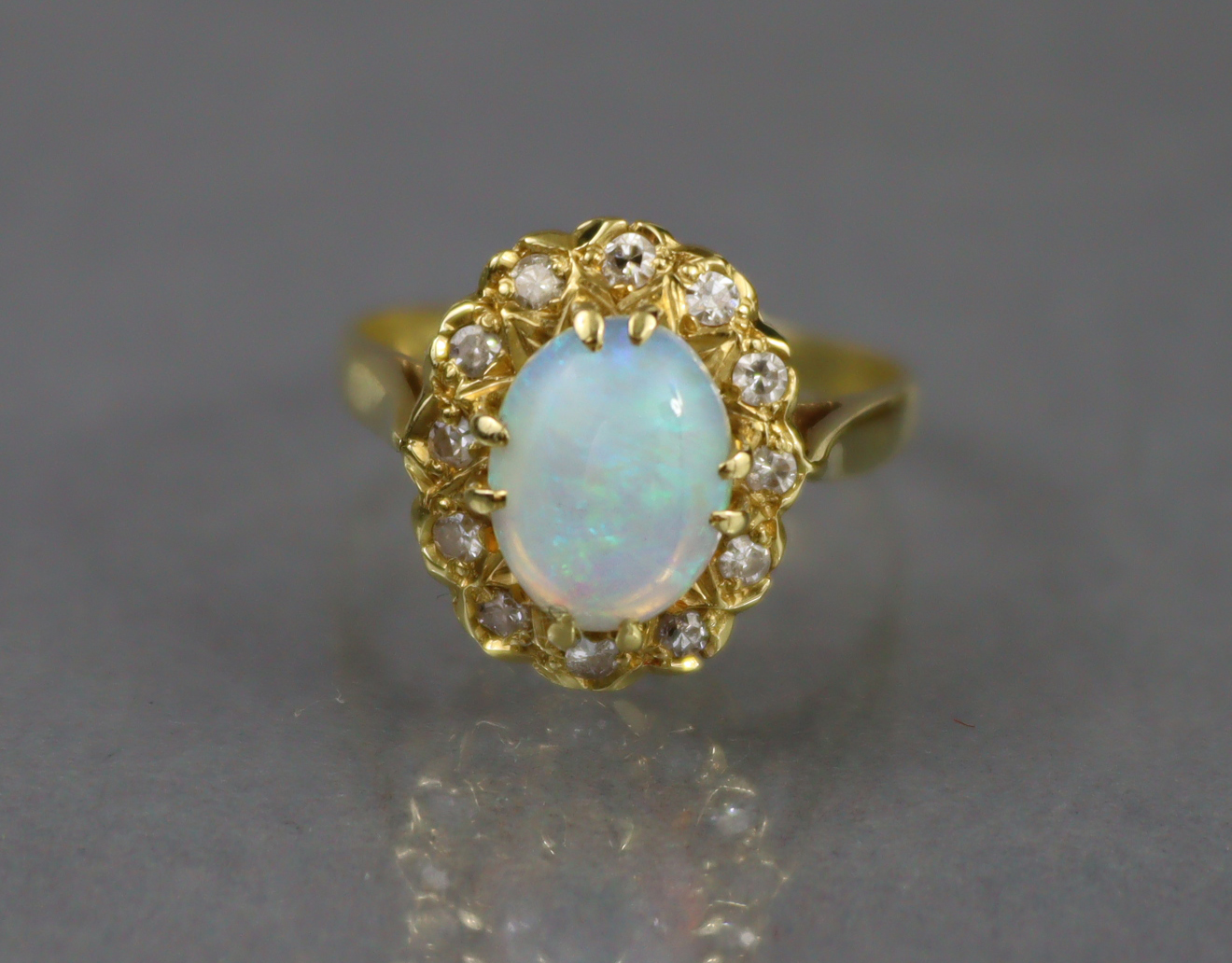 An 18ct. gold ring set oval opal within a border of small diamonds, Birmingham hallmarks for 1875; - Image 2 of 6