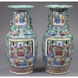 A pair of 19th century Cantonese porcelain baluster vases with chilong to the shoulders & lion-