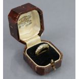 A late 19th/early 20th century 18ct. gold ring set row of seven graduated round-cut diamonds, the