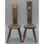 A Welsh oak spinning chair, with heavily-carved decoration to the back & seat, on four bobbin-turned