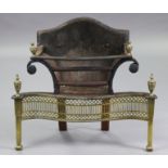 A 19th century cast-iron & brass serpentine-front fire grate with shaped back, pierced frieze &