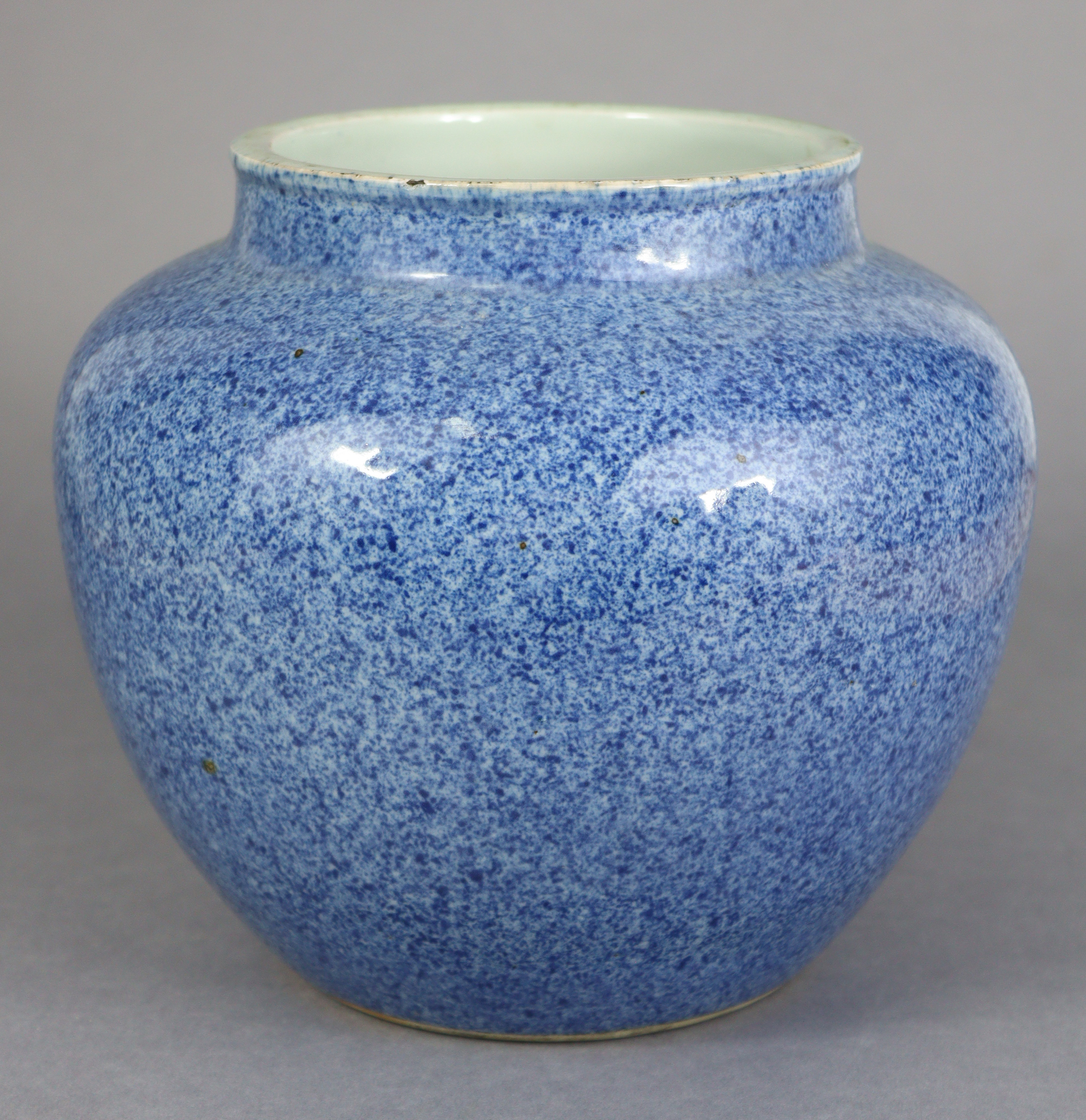 A Chinese porcelain powder-blue glazed vase, of squat round shape, with un-glazed base, 7½” high x