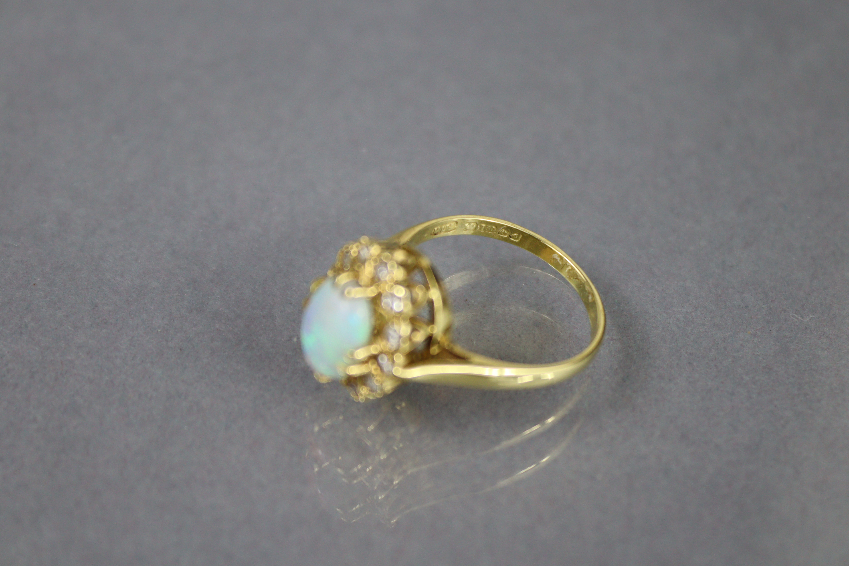 An 18ct. gold ring set oval opal within a border of small diamonds, Birmingham hallmarks for 1875; - Image 4 of 6