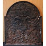 A 17th century-style cast-iron fire back with arched top & relief decoration of a coat-of-arms; 24½”