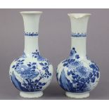 A pair of 18th century Chinese blue & white porcelain bottle vases, each with flared rim & moulded