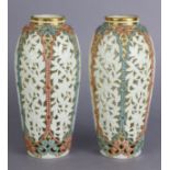 A pair of Grainger & Co. Worcester porcelain slender ovoid vases with finely pierced floral panels