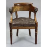 A 19th century French consulate-style carved mahogany armchair, with rounded back & lion-head arms