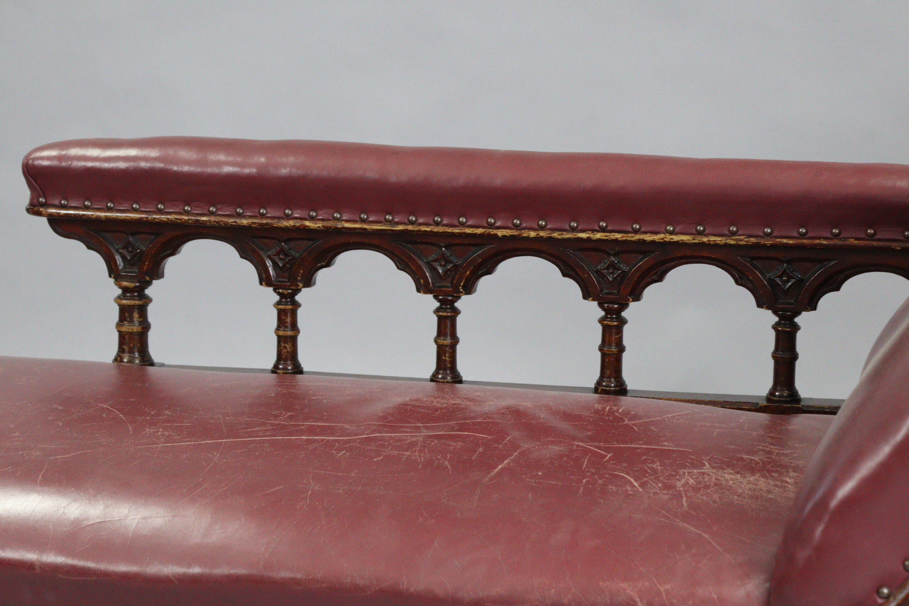 A Victorian carved oak frame chaise longue upholstered brass-studded crimson leather, with foliate - Image 3 of 6