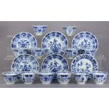 A set of twelve Chinese blue & white porcelain teabowls with shaped rims & decorated with